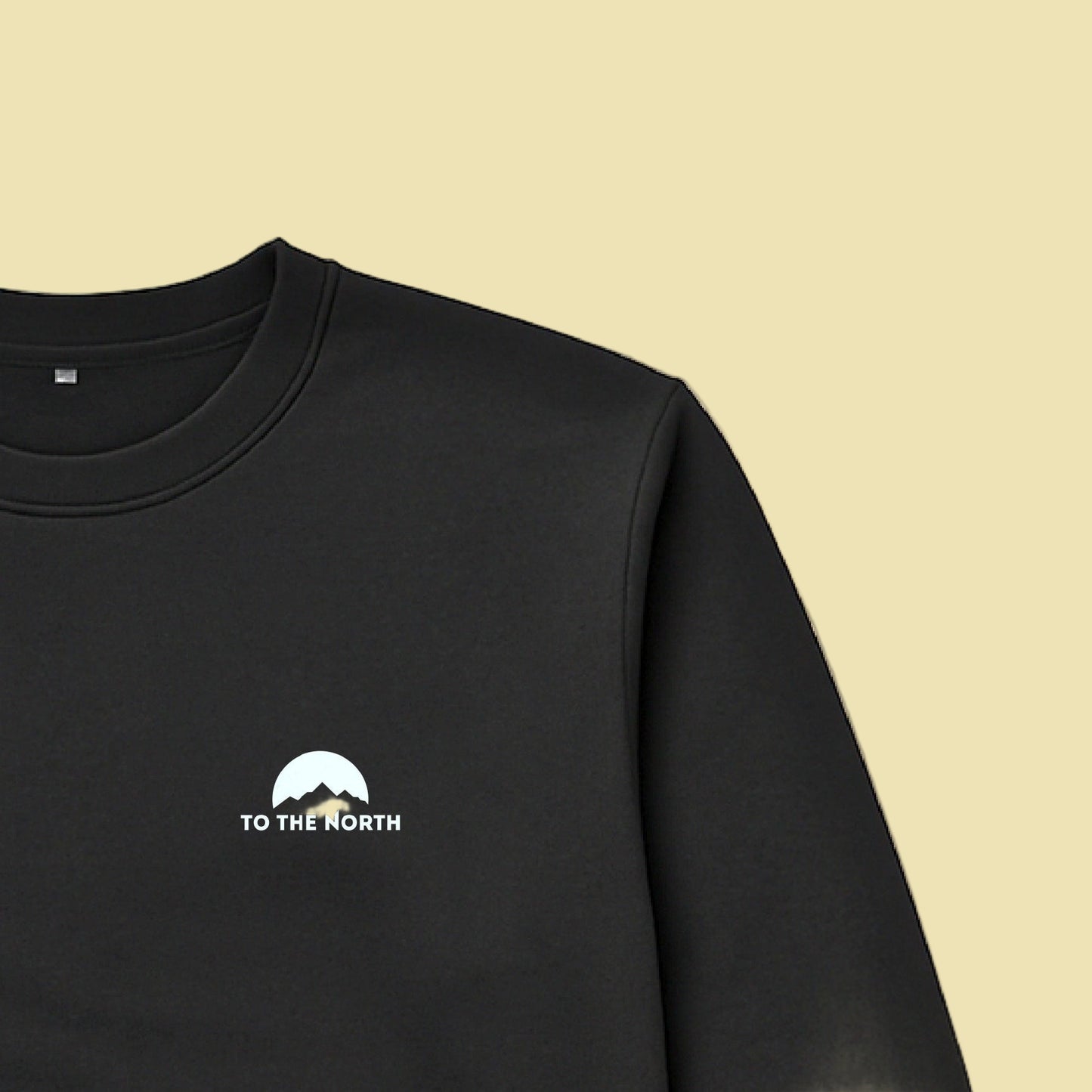 Black sweatshirt with 'To the North' logo on a beige background