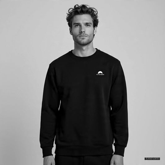 Man wearing a black sweatshirt with a logo on a gray background